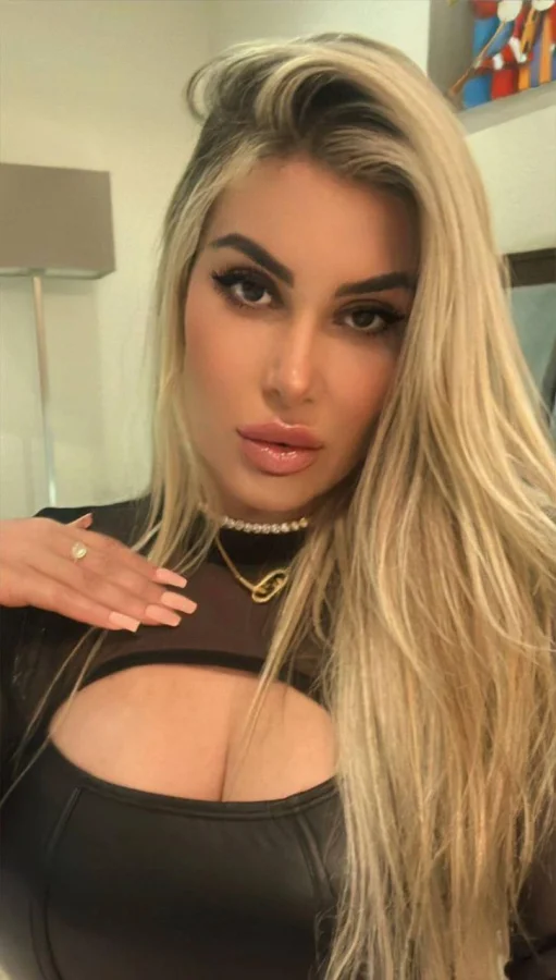 Sexy blonde escort Sunshine is wearing a black cut out dress in this selfie 