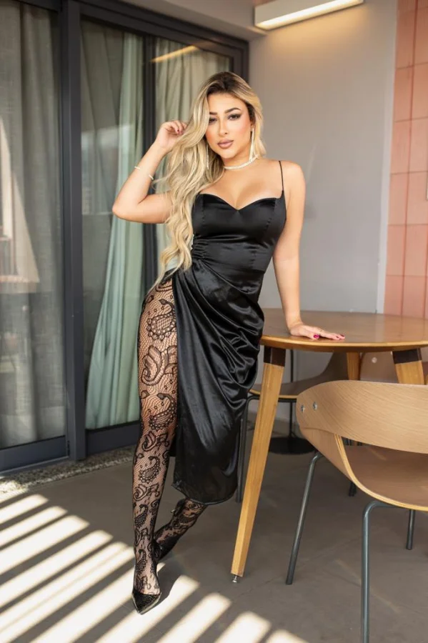 Blonde lady wearing a black dress teamed with sexy black stockings 