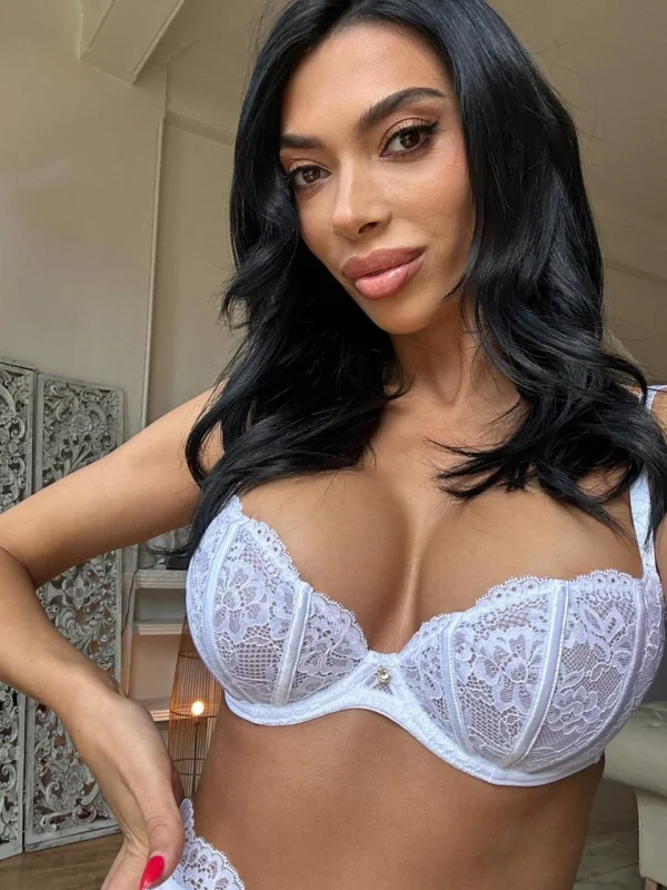 Riley looks very sexy wearing a white bra 