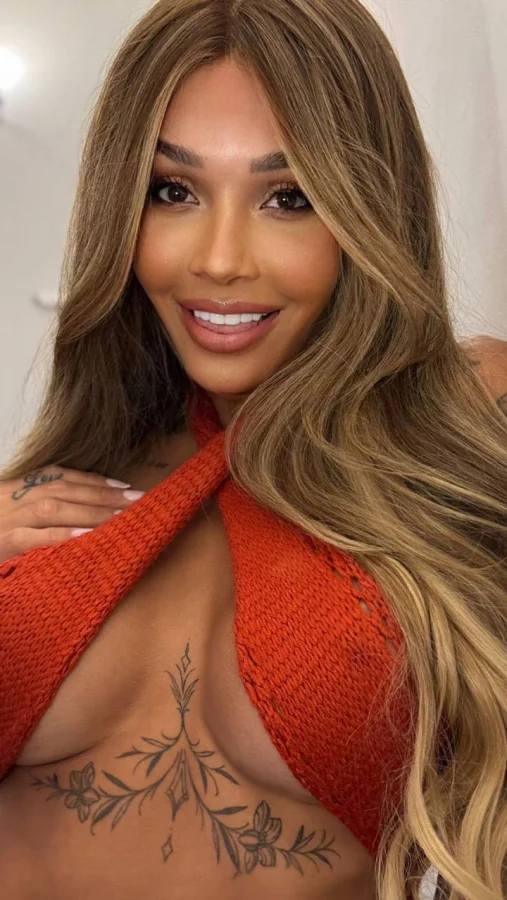 A sexy London escort from Brazil with a tattoo on her chest 