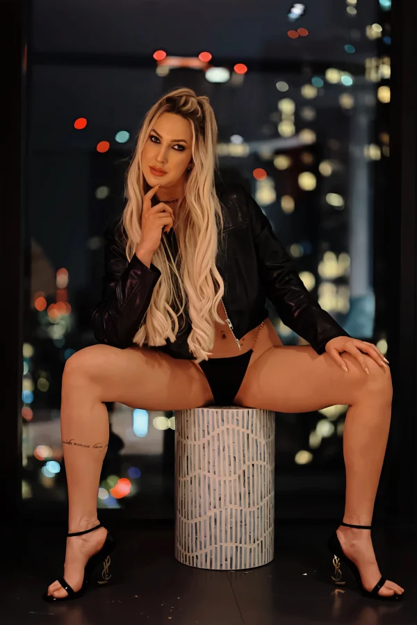 Blonde escort Carmen sat on a box with her legs wide open 