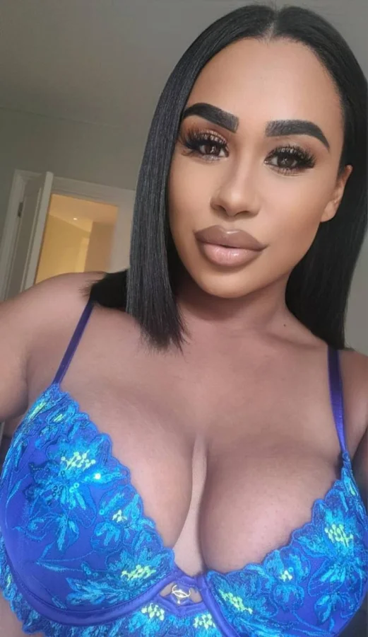 Astrid is wearing a blue bra to show off her boobs in this selfie 