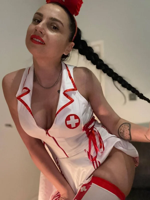 A sexy nurse with bright red blowjob lips 