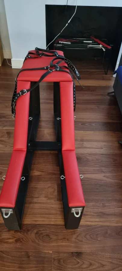 A torture chair with red padding 