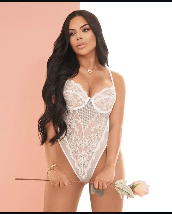 Debra looks very sexy dressed in a white lace basque 