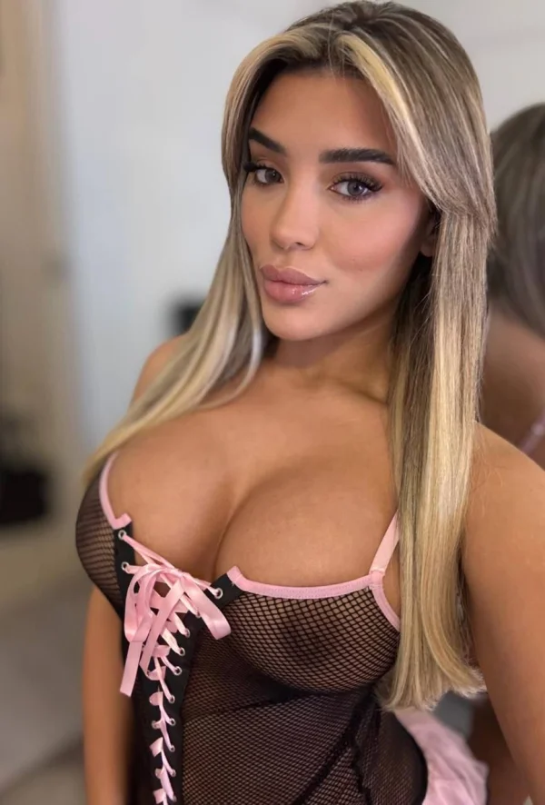 Busty British escort Tornia looking very sexy wearing a tight fitting bra 