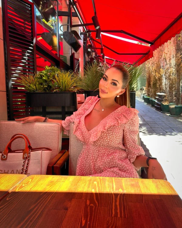 Ts Bella Morgane is sitting on a table at a restaurant 