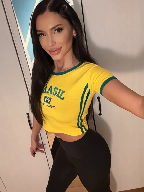 Kylie a best reviewed London escort wearing a yellow shirt 