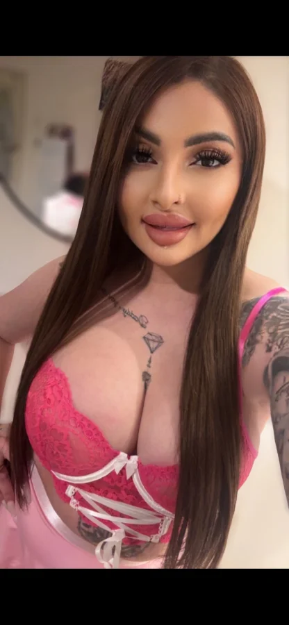 Busty London escort Diandra wearing a pink bra 