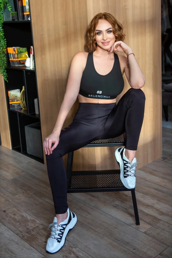 A sexy lady dressed in black gym wear 