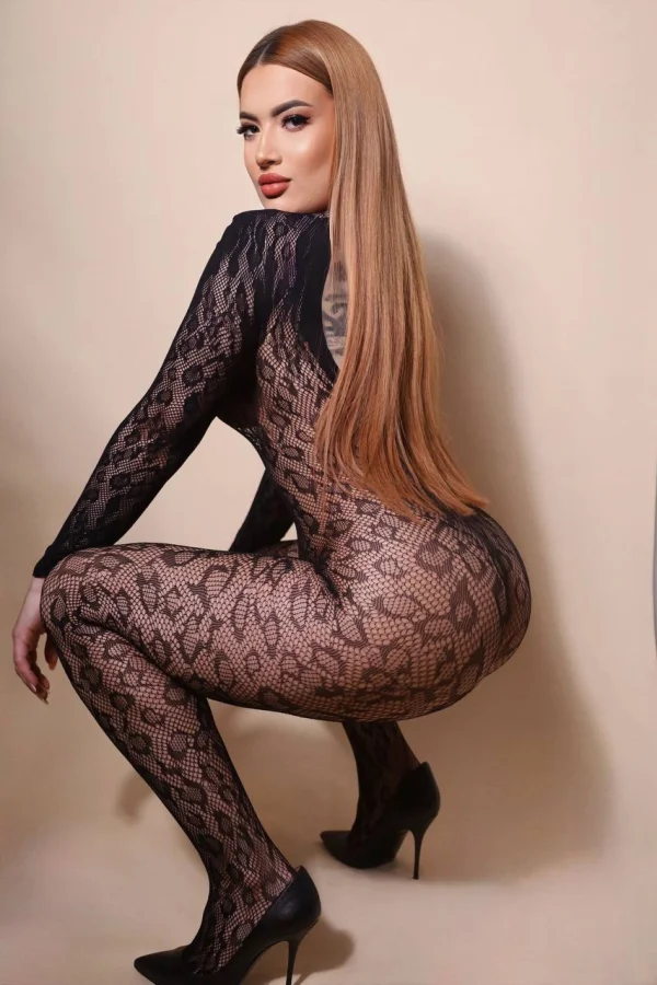 This escort in London is squatting down to show off her arse 