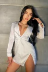 A very sexy South American escort wearing a very sexy silver dress 