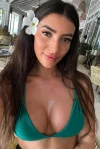 Selfie of Sunny wearing a green bikini top 